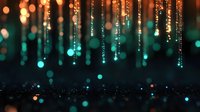 Magical glowing light strands with bokeh effect falling from above against dark background, creating dreamy atmosphere with orange and turquoise colors.