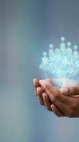 Cupped hands holding holographic smart city with glowing buildings and digital icons representing urban technology innovation and sustainable development solutions.
