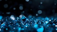 Shattered blue glass fragments and glowing particles scattered across dark background, creating abstract digital effect for technology, innovation, and modern design projects.