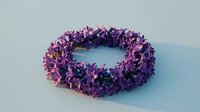 Handmade purple flower wreath with delicate blooms arranged in circular pattern on white background, isolated for craft and decoration projects.