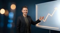 Professional businessman presenting growth chart with upward arrow trend in modern office environment for corporate success presentations.