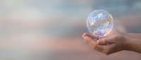Hand holding glowing crystal sphere with network connections against soft blurred background representing global communication and digital transformation.