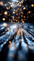 Magical glowing bokeh lights floating over dark textured surface with golden sparkles and blue tones creating dreamy atmospheric effect. Great for festive backgrounds.