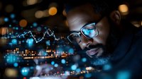 African American businessman analyzing digital financial chart data and market trends on futuristic holographic display in dark office environment.