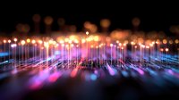 Glowing optical fiber strands emit vibrant purple, pink and orange light against dark background creating futuristic technology pattern with bokeh effect.