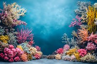 Vibrant coral reef ecosystem with colorful sea fans, soft and hard corals in pink, yellow, and white against deep turquoise ocean water background.