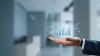 Business professional displaying holographic financial data charts and graphs in modern office environment for corporate analytics and growth visualization.