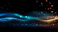 Glowing particles wave with blue and orange light effects on dark background, creating magical atmospheric motion for luxury design projects.