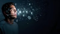 Young Caucasian man with digital data projection on face representing artificial intelligence, machine learning and futuristic technology concepts.