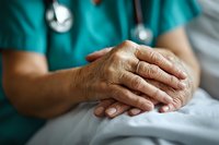 Healthcare worker in teal scrubs holding elderly patient's hands with compassion and care, providing comfort and support in medical setting. Close up view.