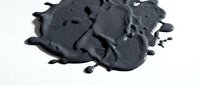 Dark gray paint splatter with irregular edges and dripping texture on white background, suitable for graphic design, digital art projects, and creative overlays.