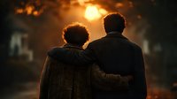 Two people embracing while watching dramatic sunset with warm golden light creating silhouettes against blurred urban background for emotional storytelling.