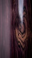 Close-up macro shot of natural wood grain texture with rich brown tones and organic patterns for interior design and carpentry projects.