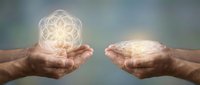 Hands holding glowing geometric mandala and brain symbols representing mind connection, spiritual energy, consciousness and mental wellness concepts.