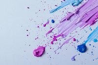 Dynamic splashes and splatters of vibrant pink and blue paint creating abstract artistic composition on white background, suitable for creative design projects.