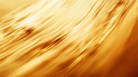Golden diagonal motion blur lines creating dynamic abstract background with warm amber tones and smooth flowing texture for luxury design projects.