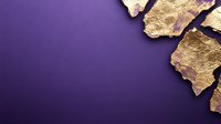 Gold leaf fragments arranged on deep purple background creating elegant contrast and negative space, suitable for luxury branding and editorial design.