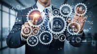 Professional businessman in suit touching glowing digital gear interface with industrial automation icons and data analytics in modern office environment.