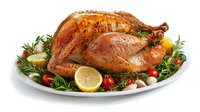 Roasted whole turkey garnished with fresh rosemary, cherry tomatoes, garlic and lemon slices served on white plate, golden brown crispy skin, holiday dinner.