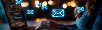Email marketing campaign concept with glowing blue envelope icons floating above laptop screen while female professional works in dark office environment.