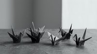 Monochrome origami paper cranes arranged on wooden surface showcasing traditional Japanese folding art and craftsmanship for meditation and mindfulness projects.