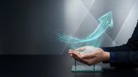 Businessman hand holding glowing upward arrow symbol representing growth, success, and financial progress in digital business and investment strategy.