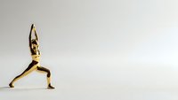 Golden metallic human figure in warrior yoga pose on neutral background. Meditation and mindfulness concept for wellness and spiritual practice.