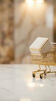 Smartphone with gold trim inside miniature shopping cart on marble surface with warm blurred background, representing mobile commerce and digital retail.