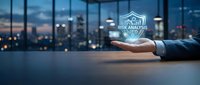 Businessman holding house icon above desk with city skyline at dusk, representing real estate investment, property management, and housing market analysis for business concepts.