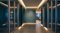 Modern office hallway with glass doors and warm LED ceiling lighting creating professional corporate interior atmosphere for business presentations.