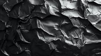 Dramatic black and white crumpled paper texture with deep shadows and highlights creating abstract patterns. Artistic background for graphic design projects.