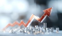 Growing financial graph with stacks of silver coins showing upward market trend and investment success on blurred background with orange glowing arrow.