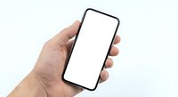 Hand holding modern smartphone with blank white screen mockup isolated on white background for app presentation and mobile interface design.