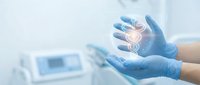 Gloved hands holding glowing digital spine symbol in medical laboratory setting, representing healthcare innovation and chiropractic treatment technology.