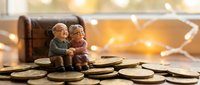Elderly couple figurines sitting on golden coins with warm bokeh lights background representing retirement savings and financial planning for senior years.