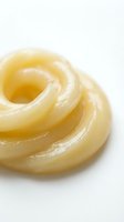 Glazed ring-shaped pastry with golden-brown spiral layers and shiny coating, isolated on white background for bakery, food, and culinary design projects.