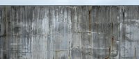 Weathered concrete wall texture with vertical streaks and stains showing industrial decay and urban grunge patterns for architectural backgrounds.