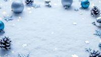 Blue Christmas ornaments and pine cones scattered on white snow background with copy space for holiday greeting cards and winter seasonal designs.