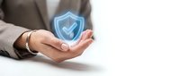 Businesswoman holding glowing blue shield with checkmark icon, representing data security, protection, and trust in digital systems for cybersecurity concepts.