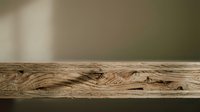 Rustic wooden table surface with natural grain patterns and knots against soft blurred beige background for product display and presentation.