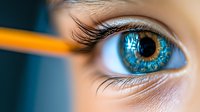 Extreme macro shot of bright blue eye with long eyelashes and pencil reflection in pupil against dark background, showcasing vision and creativity in education and art.