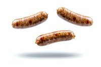 Grilled sausages floating in air on white background with soft shadow beneath. Isolated bratwurst or hot dogs showing juicy, browned exterior for food marketing.