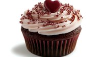 Chocolate cupcake topped with pink buttercream frosting swirl, decorated with red heart and metallic rose gold sprinkles on white background, ready for Valentine's Day celebration.