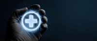 Gloved hand holding glowing medical cross symbol on dark background, representing healthcare, medicine, and digital health technology solutions.