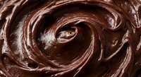 Rich chocolate frosting swirl with glossy texture and smooth creamy surface for baking and dessert projects.