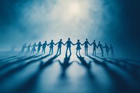 Silhouettes of people holding hands in circle casting long shadows on blue misty surface, symbolizing unity, teamwork and community support.
