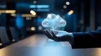 Businessman hand holding glowing cloud computing icon in modern office environment representing digital transformation and data storage solutions.