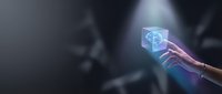 Hand holding glowing holographic cube with brain icon representing artificial intelligence, machine learning and futuristic technology concepts.