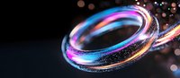 Glowing neon rings with sparkles and bokeh effects on dark background create futuristic abstract composition with luminous blue and pink light trails.