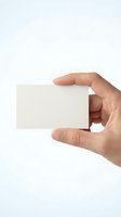 Hand holding blank white business card isolated on light background, ready for branding and corporate design mockups.
